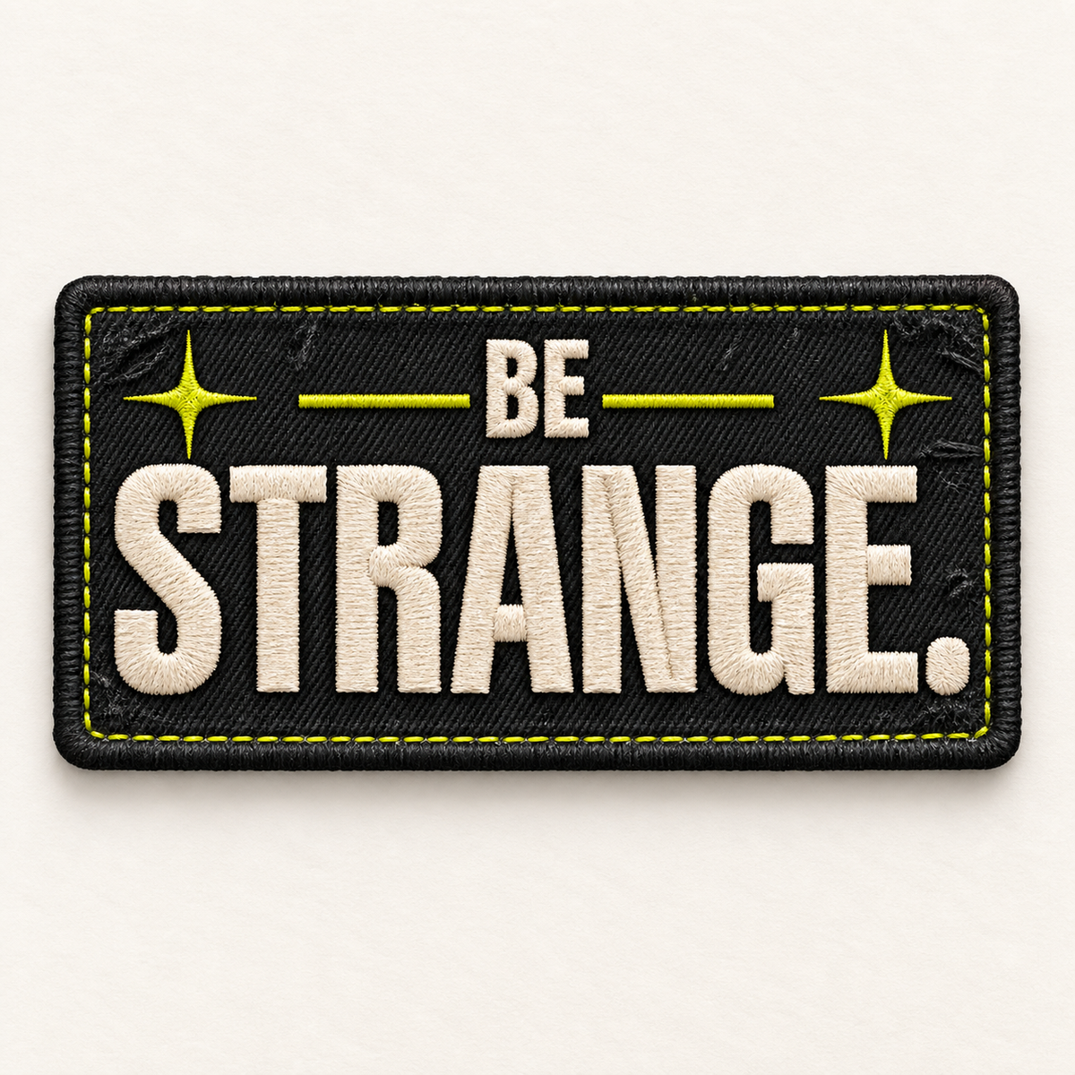 Be Strange embroidered LILMATEEN patch on cream background